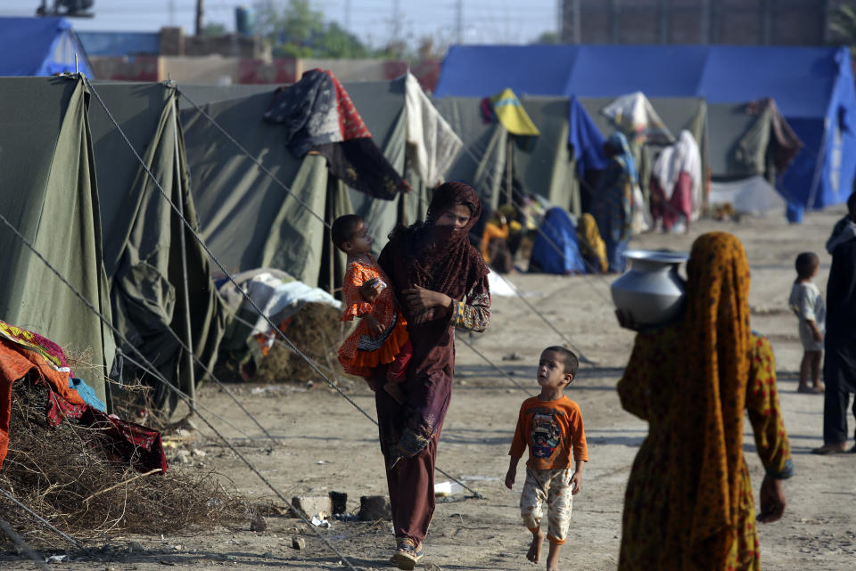 Victims of heavy flooding from monsoon rains take refuge at a temporary tent housing camp organized by the UN Refugee Agency (UNHCR), in Sukkur, Pakistan, Saturday, Sept. 10, 2022. Months of heavy monsoon rains and flooding have killed over a 1000 people and affected 3.3 million in this South Asian nation while half a million people have become homeless. (AP Photo/Fareed Khan)