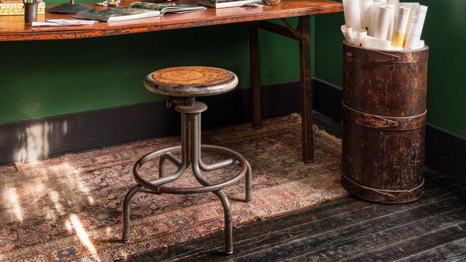 collection of antique garden shears and photo inspiration board displayed on walls painted clover green by benjamin moore in home office in cozy 1940 craftsman cottage owned by leighton, alabama, landscape gardener anthony brewington