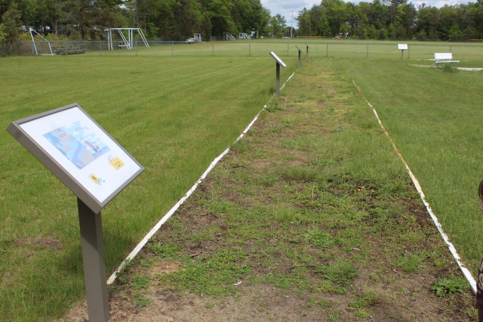 Pedestals with different pages of a book for children and their families to read are placed all around the children's playground at the northwest corner of Cooperation Park.