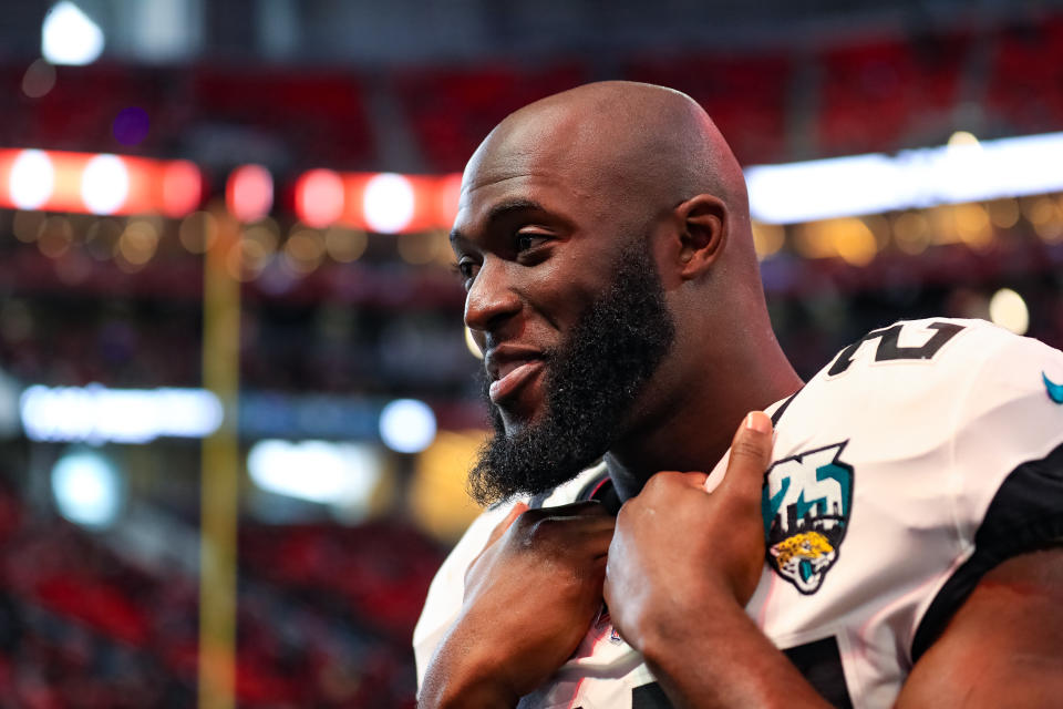 Leonard Fournette stands on the sidelines in a Jaguars uniform.