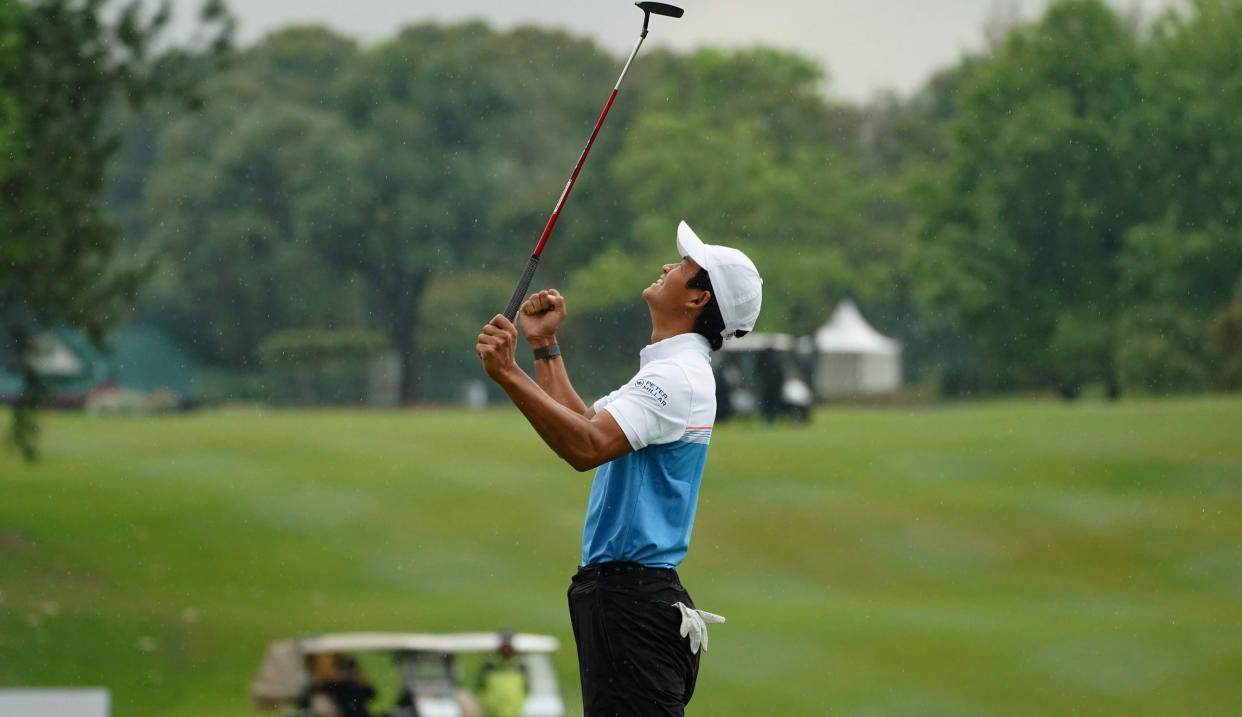  Taichi Kho shakes his fists after holing the winning putt at the 18th hole 