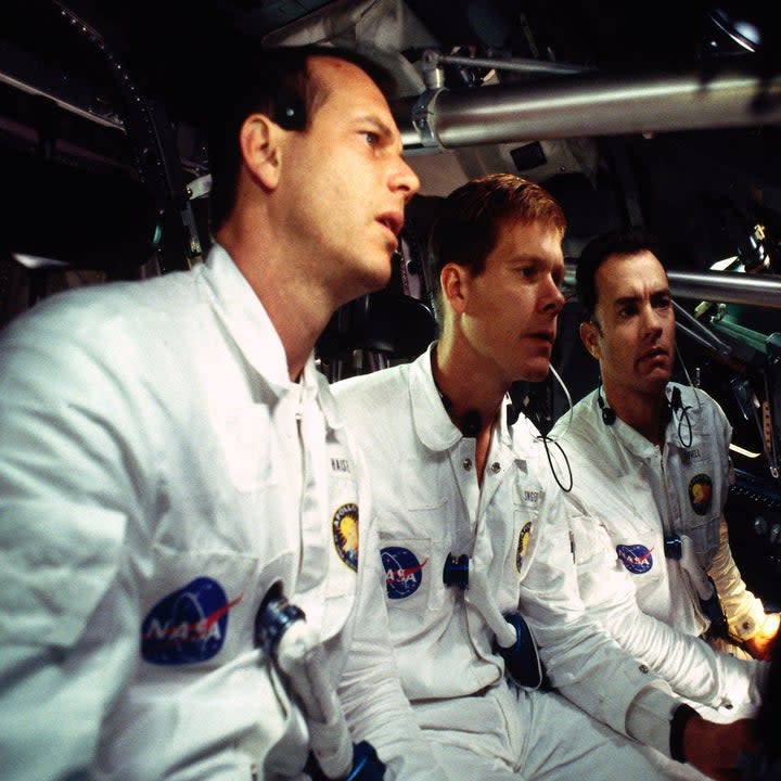 Fred Haise, Jack Swigert, and Jim Lovell wearing their NASA uniforms in the space shuttle in Apollo 13