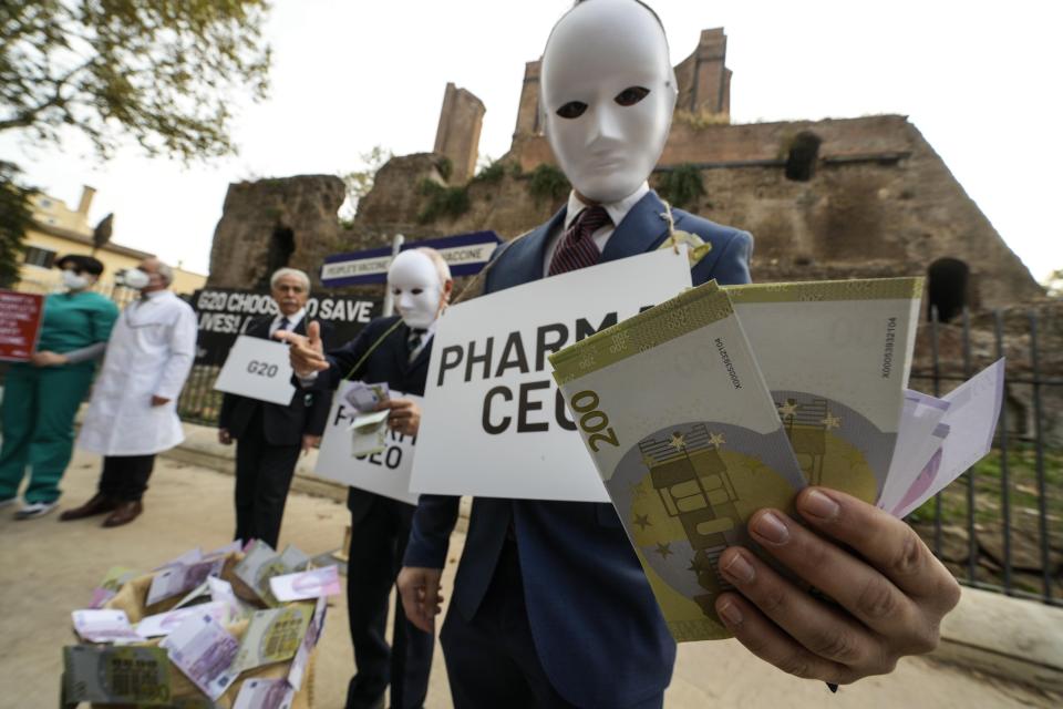 Activists of Oxfam and Amnesty International stage a flash mob in Rome, Friday, Oct. 29, 2021. Various organizations staged a flash mob in Rome to ask G20 leaders to take bold decisions to distribute vaccines in low-income countries. According to OXFAM, Amnesty International and Emergency, members of the People’s Vaccine Alliance, only 2.8% of population living in low income countries, mainly in Africa, had access to vaccines. (AP Photo/Luca Bruno)