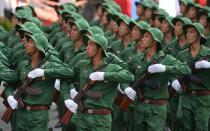 Soldiers dressed as Vietnam War era Vietcong soldiers march during a parade marking the 40th anniversary of the fall of Saigon, in Ho Chi Minh City on April 30, 2015