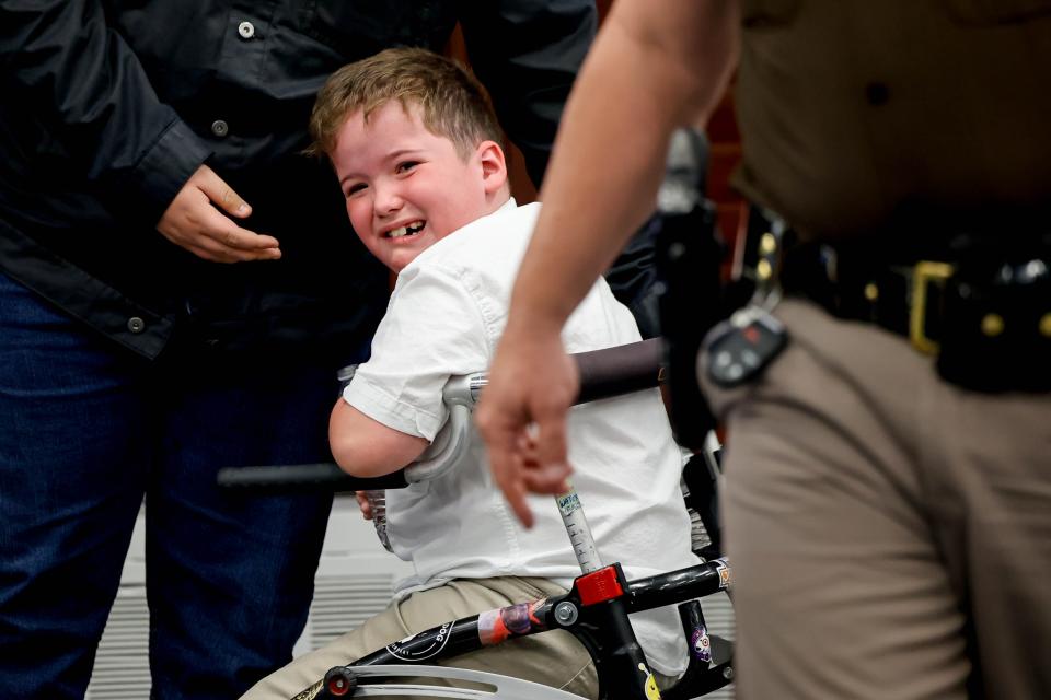 Maxwell Beasley cries on his brother Gabriel’s side after his mother, Audra Beasley, is arrested Thursday at an Oklahoma State Board of Education meeting at the state Capitol.