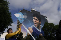 A man holds a kite during the inauguration of the mural of Diego Maradona by artist Martin Ron in Buenos Aires, Argentina, Sunday, Oct. 30, 2022. Sunday marks the birth date of Maradona who died on Nov. 25, 2020 at the age of 60.(AP Photo/Rodrigo Abd)