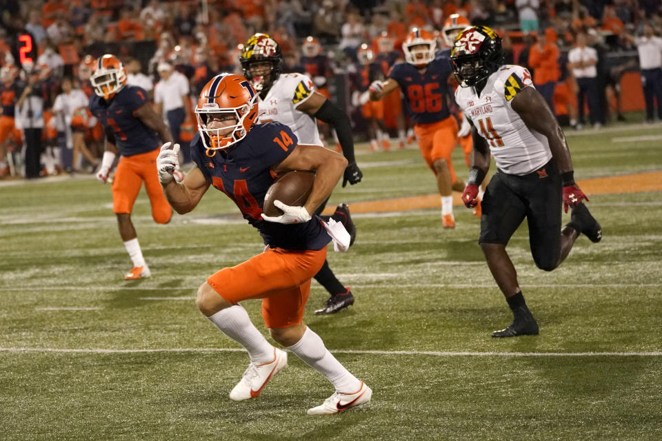 Illinois wide receiver Casey Washington heads for the end zone after picking up teammate Reggie Love's fumble during the second half of the team's NCAA college football game against Maryland on Friday, Sept. 17, 2021, in Champaign, Ill. Maryland won 20-17. (AP Photo/Charles Rex Arbogast)