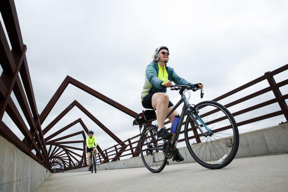 Cyclists ride across the High Trestle Trail Bridge during the annual Pigtails ride along the High Trestle trail on Saturday, May 22, 2021, in Madrid, IA. 