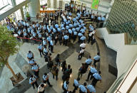 Police officers gather at the lobby of headquarters of Apple Daily in Hong Kong Thursday, June 17, 2021. Hong Kong police on Thursday morning arrested the chief editor and four other senior executives of Apple Daily under the national security law on suspicion of collusion with a foreign country to endanger national security, according to local media reports. (Apple Daily via AP)