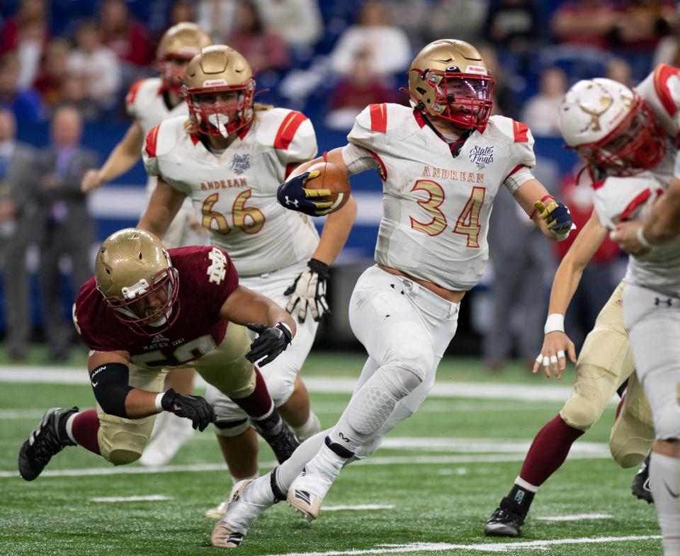 Mater Dei's James Ralph (50) attempts a tackle on Andrean's Drayk Bowen (34) during the IHSAA Class 2A football state championship between the Mater Dei Wildcats and the Andrean Fighting 59ers at Lucas Oil Stadium in Indianapolis, Ind., Saturday afternoon, Nov. 27, 2021.