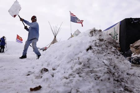 Benji Buffalo works to improve his campsite inside of the Oceti Sakowin camp as "water protectors" continue to demonstrate against plans to pass the Dakota Access pipeline near the Standing Rock Indian Reservation, near Cannon Ball, North Dakota, U.S., December 2, 2016. REUTERS/Lucas Jackson