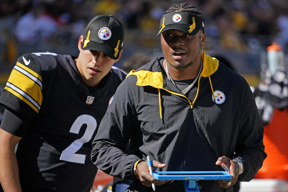 FILE - Pittsburgh Steelers quarterbacks Mason Rudolph, left, and Dwayne Haskins stand on the sideline during the second half an NFL football game against the Cincinnati Bengals, Sunday, Sept. 26, 2021, in Pittsburgh. Rudolph and Haskins will be given a chance to be the Pittsburgh Steelers starting quarterback in 2022 with veteran Ben Roethlisberger expected to retire after an 18-year career.(AP Photo/Gene J. Puskar, File)