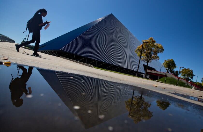 Long Beach, CA., March 11, 2020 - A student passes by The Walter Pyramid at Cal State Long Beach, where the campus has gone to online only classes on Tuesday, March 11, 2020 in Long Beach, California. (Jason Armond / Los Angeles Times)