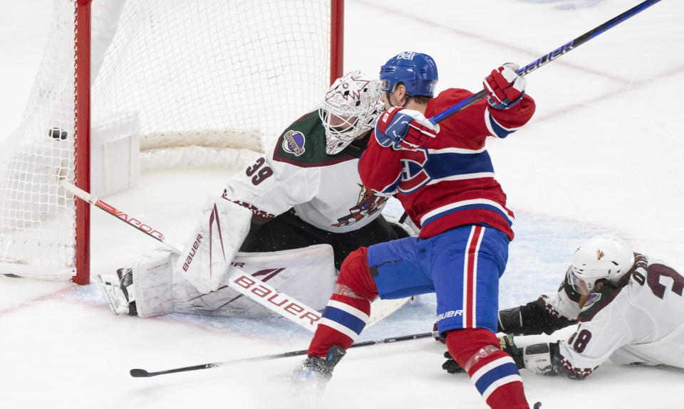 Montreal Canadiens' Tanner Pearson (70) scores on Arizona Coyotes goaltender Connor Ingram (39) as Coyotes' Liam O'Brien (38) tries to defend during the third period of an NHL hockey game, Tuesday, Feb. 27, 2024 in Montreal. (Christinne Muschi/The Canadian Press via AP)