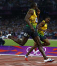 Jamaica's Usain Bolt celebrates as he crosses the finish line to win the men's 200m final ahead of compatriot Yohan Blake (R) during the London 2012 Olympic Games at the Olympic Stadium August 9, 2012. REUTERS/Eddie Keogh (BRITAIN - Tags: OLYMPICS SPORT ATHLETICS) 