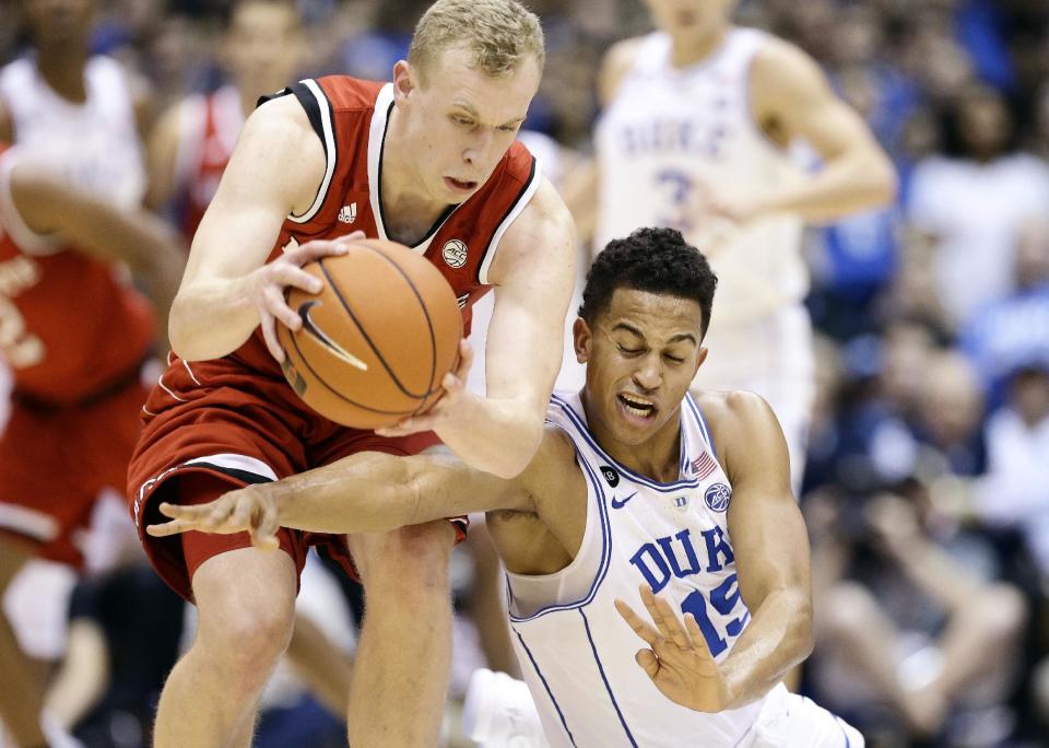 N.C. State's Maverick Rowan, left, and Duke's Frank Jackson (15) chase a loose ball during the first half of an NCAA college basketball game in Durham, N.C., Monday, Jan. 23, 2017. (AP Photo/Gerry Broome)