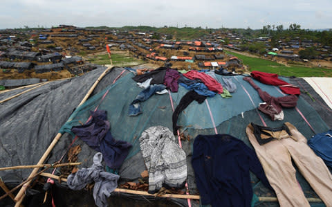 Clothes belonging to Rohingya Muslim refugees dry on a temporary shelter in Balukhali refugee camp  - Credit: DOMINIQUE FAGET/AFP/Getty Images