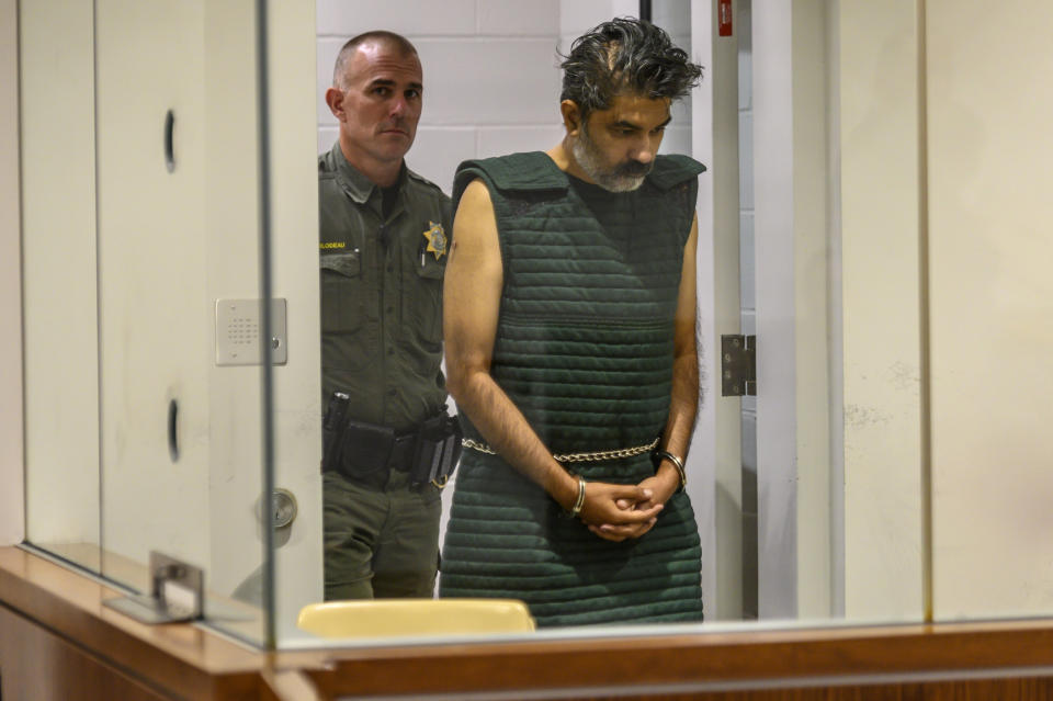 Shankar Hangud, wearing a personal safety vest, appears in the Placer County Superior Court Wednesday, Oct. 16, 2019, in Roseville, Calif. Prosecutors say Hangud faces murder charges for allegedly killing four members of his family in Northern California. (Renee C. Byer/The Sacramento Bee via AP, Pool)