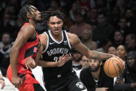 Brooklyn Nets forward Noah Clowney (21) drives against Toronto Raptors guard Immanuel Immanuel Quickley during the first half of an NBA basketball game, Wednesday, April 10, 2024, in New York. (AP Photo/Mary Altaffer)