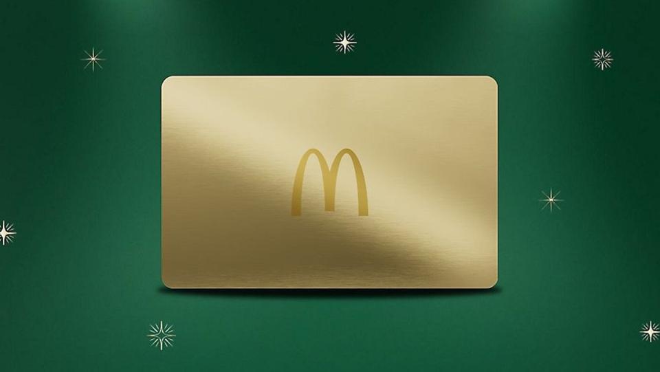 A gold McDonald's McGold Card with a single arch logo on a green background