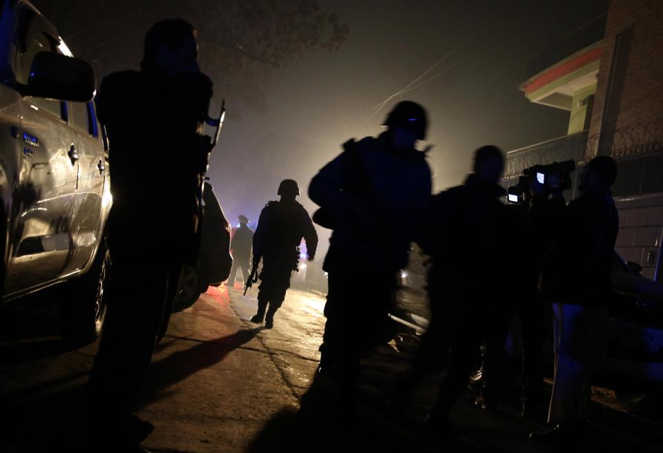 Afghan security forces arrive at the site of an explosion in Kabul, Afghanistan, Friday, Jan. 17, 2014. Afghan police said a suicide bomber attacked a Kabul restaurant popular with foreigners, officials. (AP Photo/Massoud Hossaini)