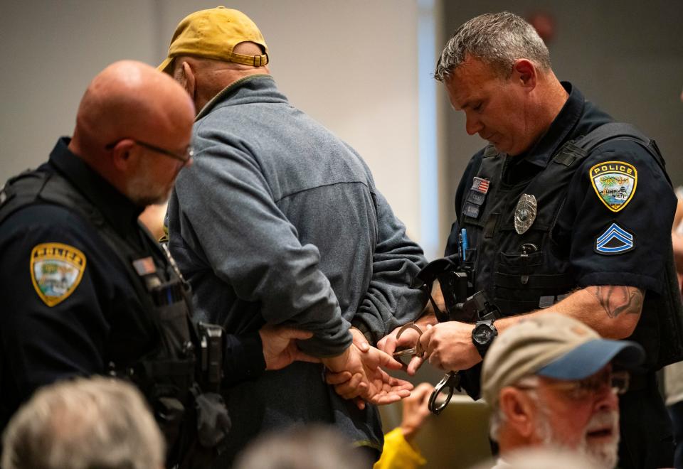 Scott Kempe is arrested by police officers before being escorted out of a city council meeting at Cape Coral City Hall in Cape Coral on Wednesday, Dec. 13, 2023. After being escorted out of a previous meeting, the council was slated to discuss whether he could return.