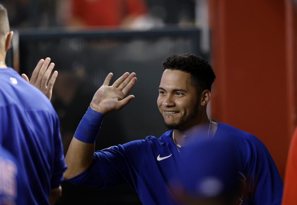 Chicago Cubs' Willson Contreras is congratulated after scoring the go-ahead run during the ninth inning of the team's baseball game against the Arizona Diamondbacks on Saturday, May 14, 2022, in Phoenix. (AP Photo/Chris Coduto)