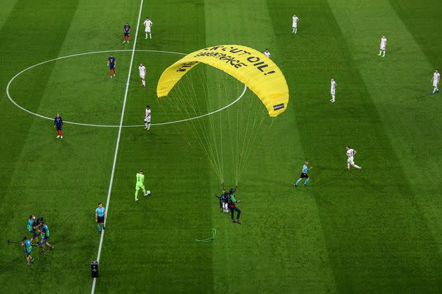 Greenpeace has apologized and Munich police are investigating after a protester parachuted into the stadium and injured two people before Germany’s game against France at the European Championship. (Photo: Markus Gilliar via Getty Images)