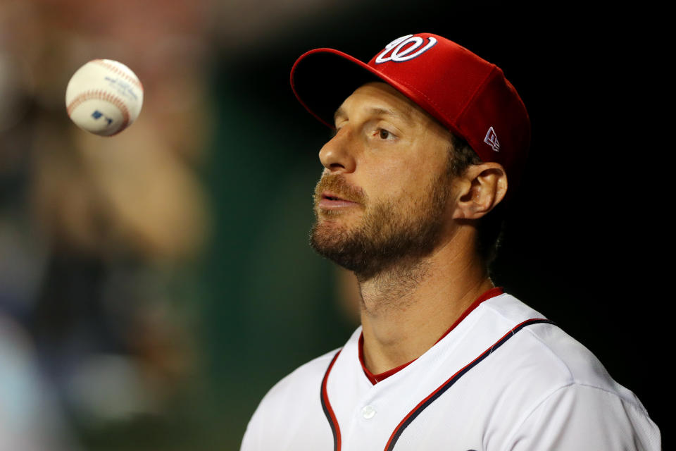 WASHINGTON, DC - OCTOBER 06:  Max Scherzer #31 of the Washinton Nationals flips a ball in the dugout during Game 3 of the NLDS between the Los Angeles Dodgers and the Washington Nationals at Nationals Park on Sunday, October 6, 2019 in Washington, District of Columbia. (Photo by Alex Trautwig/MLB Photos via Getty Images)