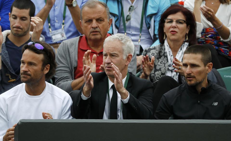 John McEnroe did make an appearance at Raonic's match between television duties. As it turns out, he may have been there at the right time – on hand to give Raonic some advice during a short rain delay. (REUTERS/Stefan Wermuth)