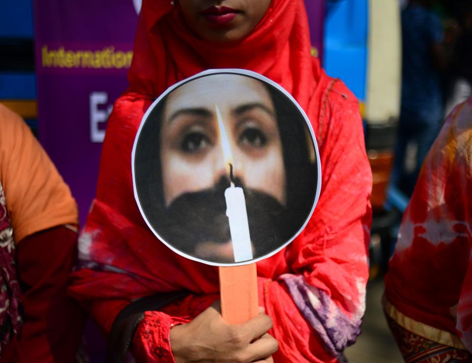 <p>A Bangladeshi woman holding a placard takes part in a rally to mark International Women’s Day in Dhaka on March 8, 2018. Thousands of Bangladeshi women, nongovernmental organizations, and rights groups activists took to the streets, demanding safer lives for women in the country as well as an improvement in their social conditions. (Photo: Munir Uz Zaman/AFP/Getty Images) </p>