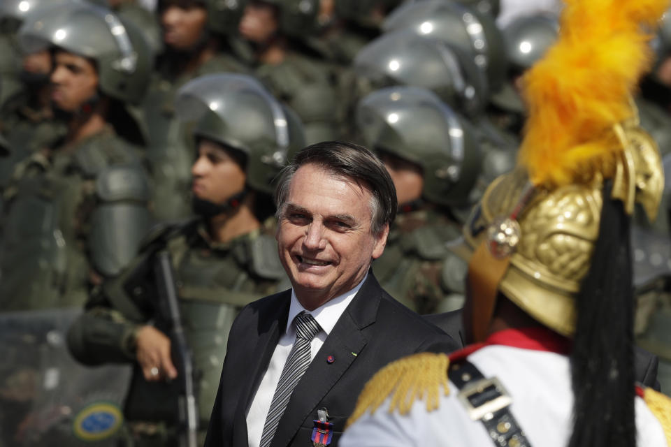 Brazils President Jair Bolsonaro arrive to attend a military ceremony for the Day of the Soldier, at Army Headquarters in Brasilia, Brazil, Friday, Aug. 23, 2019. Bolsonaro says he's leaning toward sending the army to help fight Amazon fires that have alarmed people across the globe. (AP Photo/Eraldo Peres)