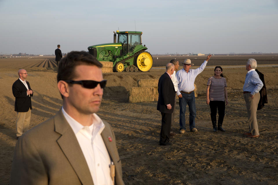 President Barack Obama, second from left in group, tours a local farm with Governor Jerry Brown, left, Joe Del Bosque of Empresas Del Bosque, Inc., and Maria Gloria Del Bosque also of Empresas Del Bosque, Inc.,and Rep. Jim Costa, D-Calif., in Los Banos, Calif., Friday, Feb. 14, 2014, where he spoke about the drought. (AP Photo/Jacquelyn Martin)