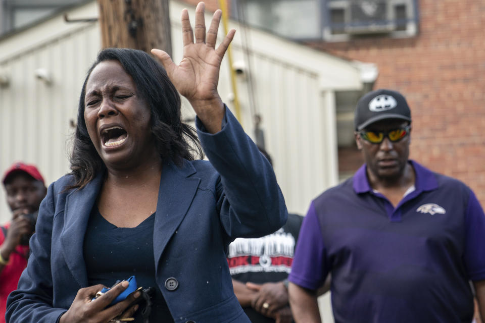 Pastor Ebony Harvin leads a prayer gathering at the site of the mass shooting.