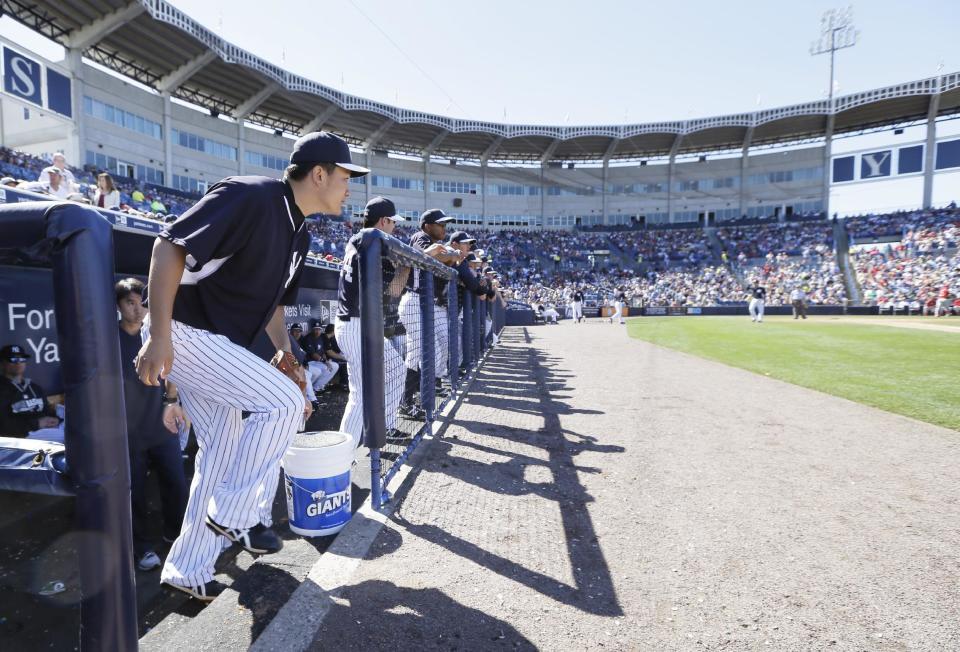New York Yankees pitcher Masahiro Tanaka runs out of the dugout before pitching in the fifth inning of an exhibition baseball game against the Philadelphia Phillies Saturday, March 1, 2014, in Tampa, Fla. (AP Photo/Charlie Neibergall)