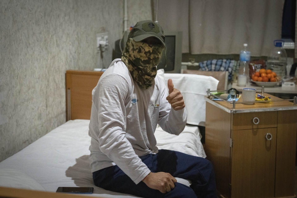 A wounded Colombian professional soldier, who joined the Ukrainian armed forces to help fight Russia, gives the thumbs up in a hospital in Ukraine on Wednesday, Dec. 20, 2023. After two years of war, Ukraine is looking for ways to replenish its depleted ranks, and the Colombian professional soldiers are a welcome addition. (AP Photo/Efrem Lukatsky)