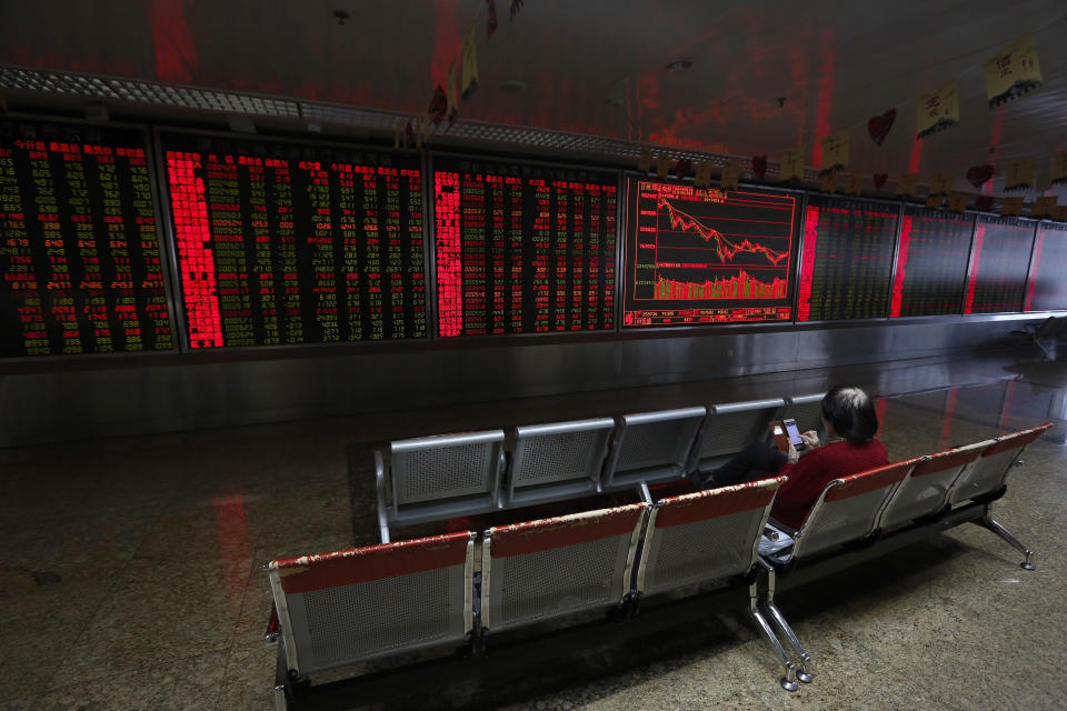 An investor monitors shares prices at a brokerage house in Beijing, Tuesday, Jan. 22, 2019. Asian markets were mostly lower on Tuesday after the International Monetary Fund trimmed its global outlook for 2019 and 2020. This came after China said its economy grew at the slowest pace in 30 years. (AP Photo/Andy Wong)