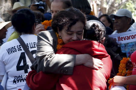 Claudia Paz, President of the Inter-American Commission on Human Rights (IACHR), is embraced by the mother of a missing student, after delivering their final report on the disappearance of the 43 students at Ayotzinapa teacher training college in Tixtla, Guerrero state, Mexico, April 27, 2016. REUTERS/Ginnette Riquelme