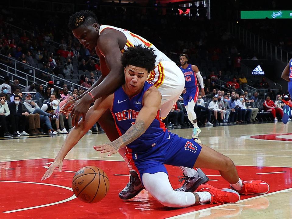 Pistons guard Killian Hayes battles for a loose ball against Hawks center Clint Capela during the first half on Monday, Oct. 25, 2021, in Atlanta.