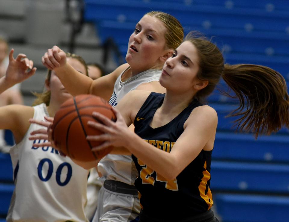 Mackenzie Ulery of Whiteford is pressured by Dundee's Kaylee Imo during a 48-22 Whiteford win Tuesday night.