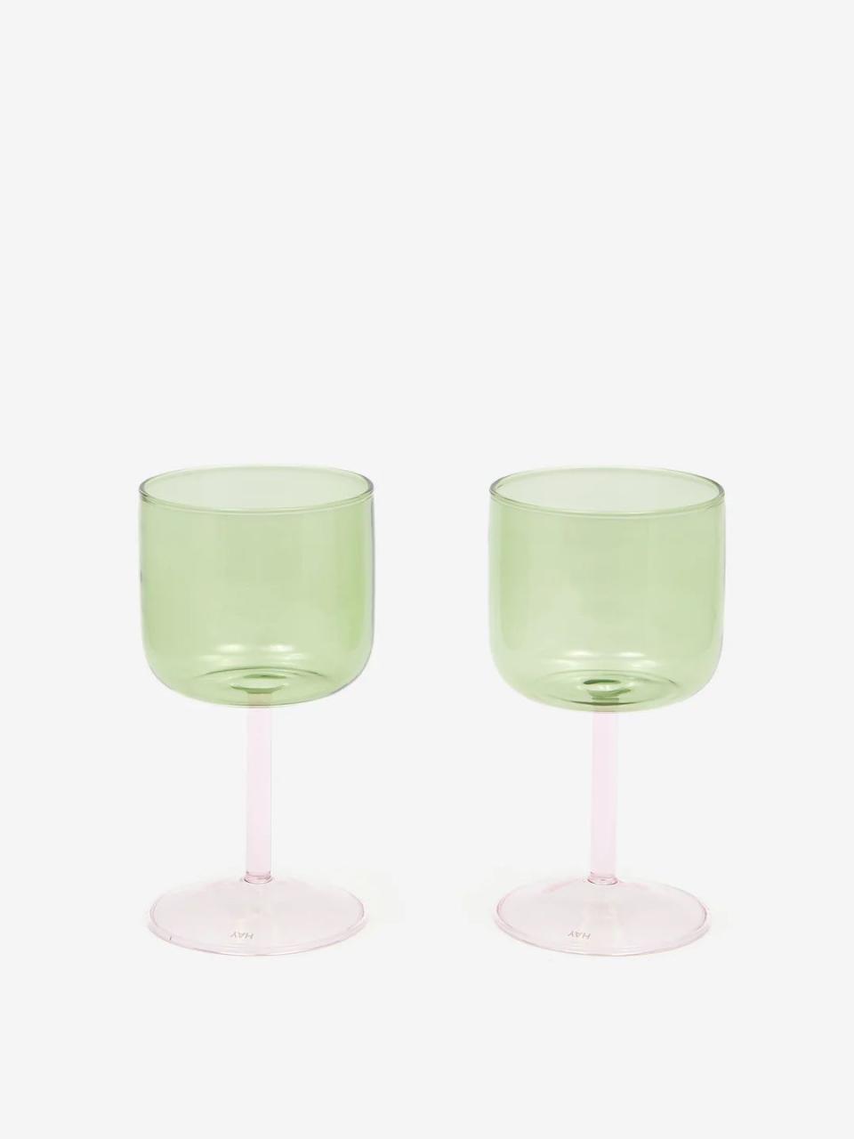 a pair of green and pink wine glasses