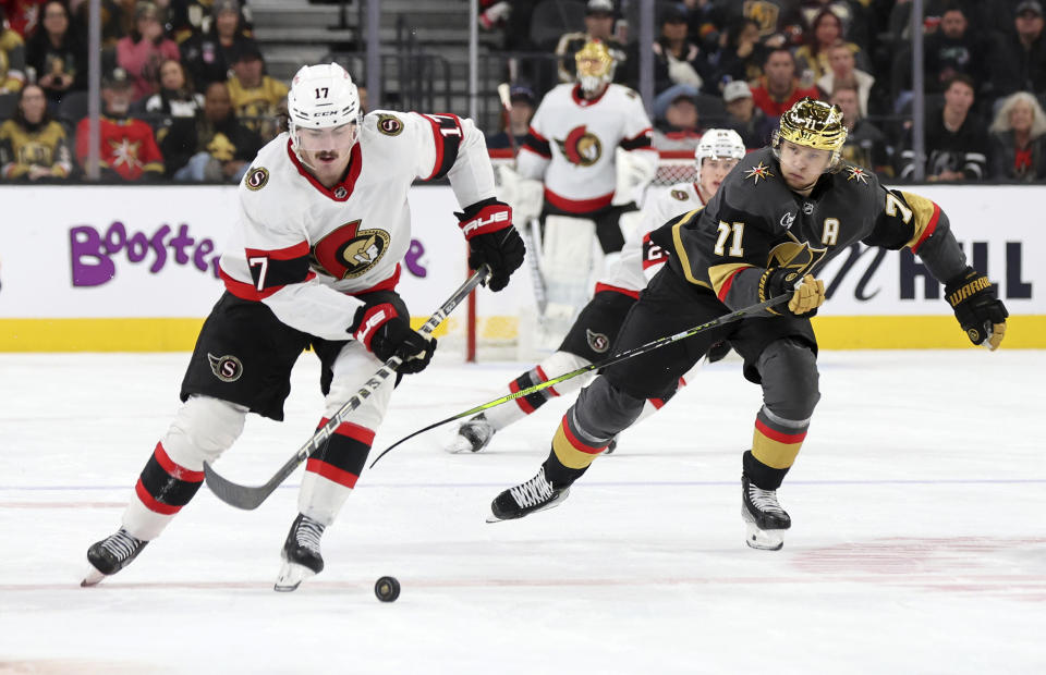 Ottawa Senators right wing Zack MacEwen (17) and Vegas Golden Knights center William Karlsson (71) skate after the puck during the third period of an NHL hockey game Sunday, Dec. 17, 2023, in Las Vegas. (AP Photo/Steve Marcus)