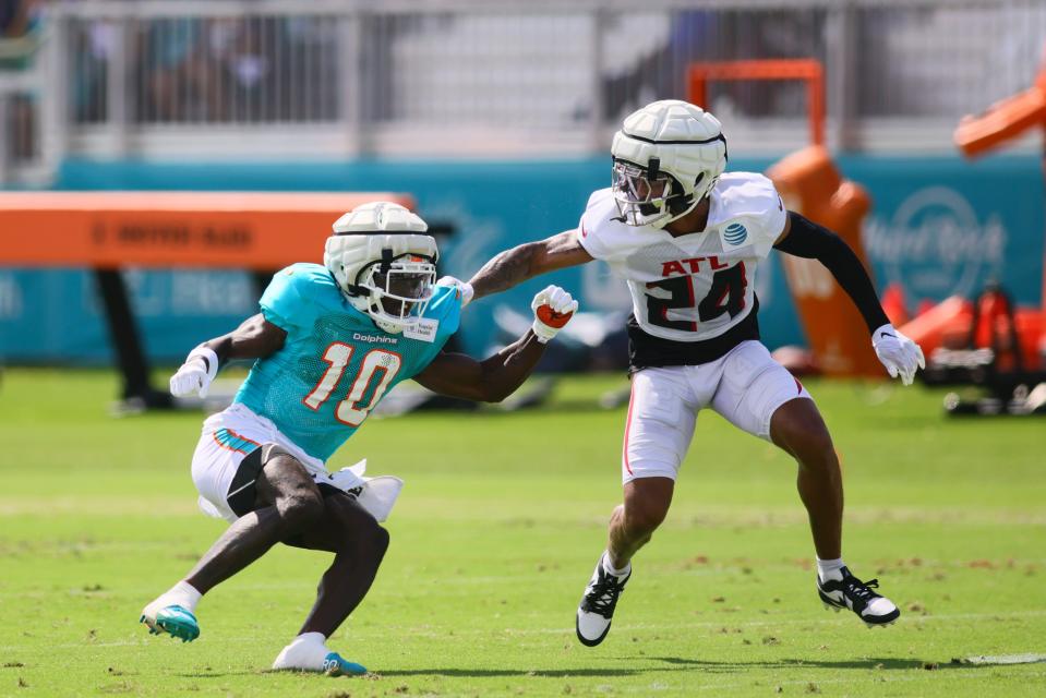 Dolphins receiver Tyreek Hill runs against Falcons cornerback A.J. Terrell during joint workouts.