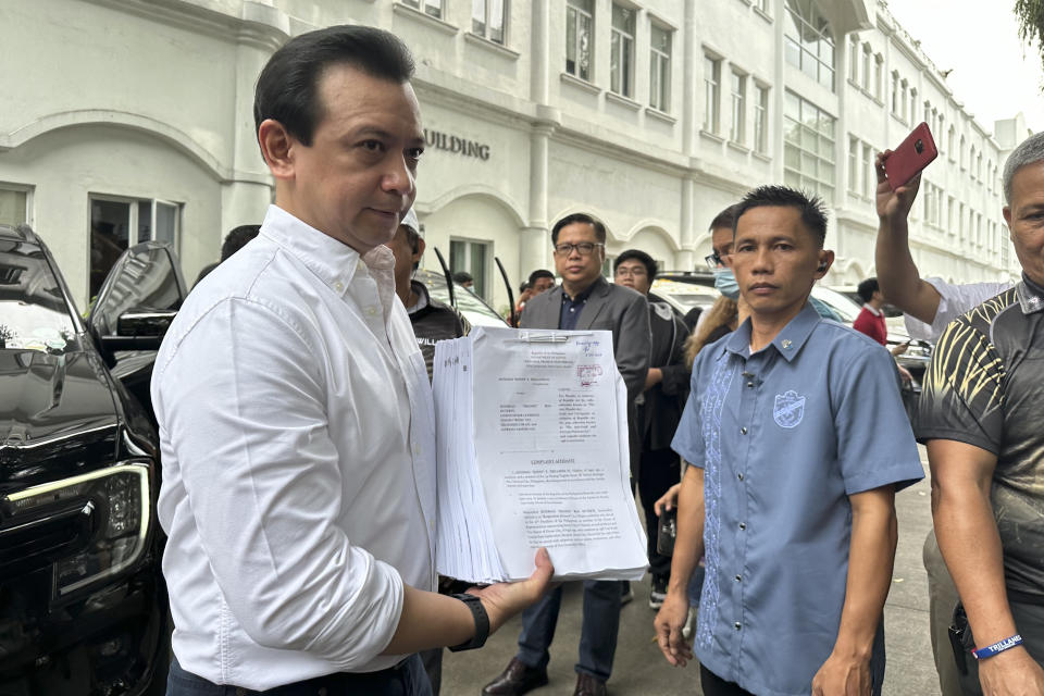 Former Sen. Antonio Trillanes holds documents as he poses for reporters after filing at the Department of Justice in Manila, Philippines on Friday July 5, 2024. Trillanes filed criminal complaints of economic plunder against ex-President Rodrigo Duterte Friday over alleged anomalies in the awarding of large numbers of government infrastructure projects worth billions of pesos (millions of dollars) to two companies when he was a southern city mayor and later as president. (AP Photo/Joeal Calupitan)