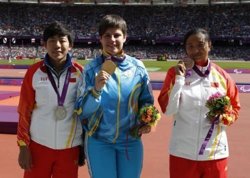 Discus athletes Ukraine's Mariia Pomazan (C) poses with China's Wu Qing (L) and China's Bao Jiongyu (R) during the London 2012 Paralympic Games. Organisers admitted that the first field event gold medallist -- Pomazan -- was wrongly awarded the F35/36 discus title