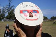 <p>A woman looks through eclipse viewing glasses at an annular solar eclipse, on Sept. 1, 2016, in Saint-Louis, on the Indian Ocean island of La Reunion. (Photo: Richard Bouhet/AFP/Getty Images) </p>