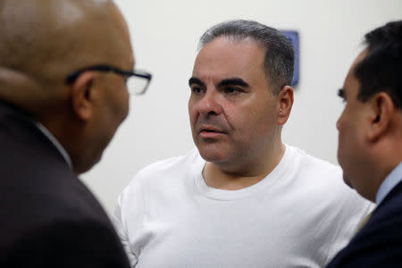 El Salvador's former President Elias Antonio Saca talks with his lawyers before his hearing on corruption charges in San Salvador, El Salvador, September 12, 2018. REUTERS/Jose Cabezas