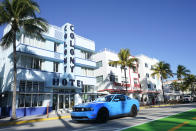 FILE — A car drives past Art Deco hotels, Jan. 24, 2022, in Miami Beach, Florida's famed South Beach. A small but well-publicized group of cryptocurrency enthusiasts called City Coins, is asking Miami and New York to accept the equivalent of millions of dollars in a new cryptocurrency scheme that has political leaders in other cities clamoring to get in on the deal. (AP Photo/Wilfredo Lee, File)