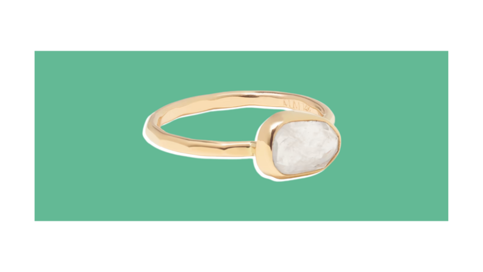 This environmentally-friendly ring features a moonstone surrounded by a hammered recycled gold setting and band.