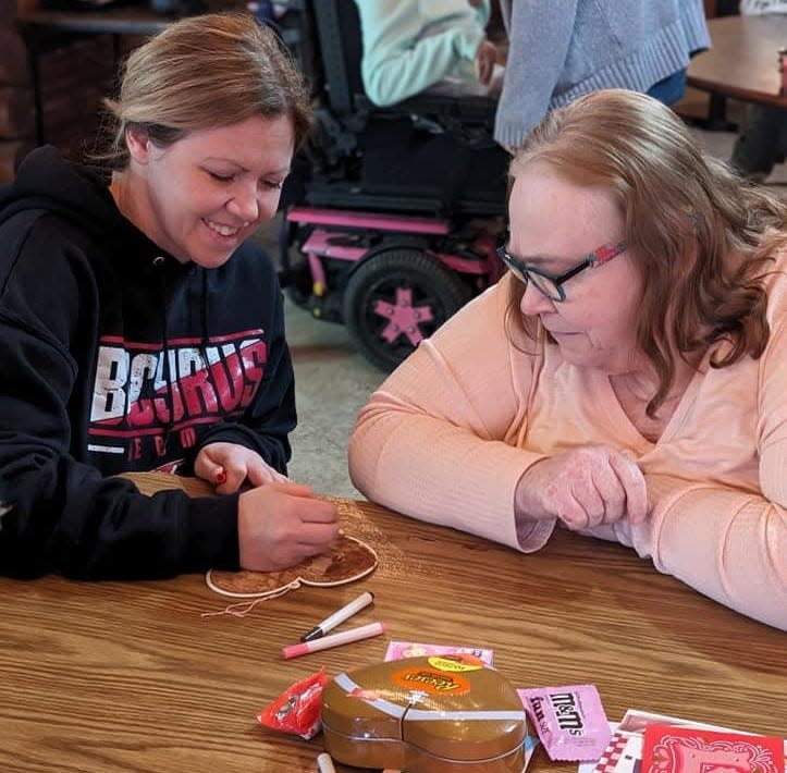 Chrysalis Advantage Point team member Ashley Weiler works with client Melody Fulton during a recent event at the agency.